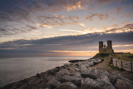 Reculver / UK -  2020.08.01: Remains of Reculver church towers at early october sunrise  early october sunriseの写真素材