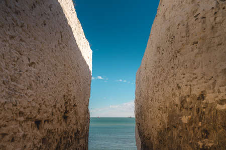 Broadstairs, Kent / UK -  2020.08.01: Empty Kingsgate Beach, walking through the chalk stacks clifs at Botany Bay in Kent, England.の写真素材