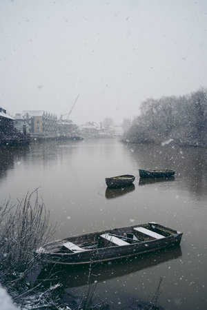 Richmond Upon Thames, London | UK -  2021.01.24: Boats covered in snow and moored on the river in West part of the cityの写真素材