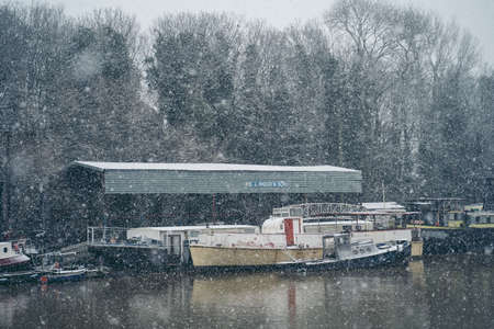 Richmond Upon Thames, London | UK -  2021.01.24: Boats covered in snow and moored on the river in West part of the cityのeditorial素材