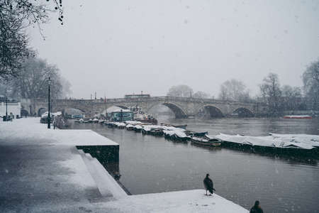 Richmond Upon Thames, London | UK -  2021.01.24: Boats covered in snow and moored on the river in West part of the cityのeditorial素材