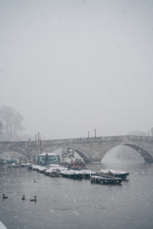 Richmond Upon Thames, London | UK -  2021.01.24: Boats covered in snow and moored on the river in...