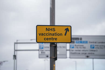 Heathrow Airport, London | UK -  2021.03.27: NHS vaccination centre at Heathrow Airport sign.のeditorial素材