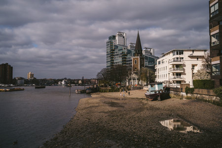 Battersea, London | UK -  2021.04.03: View of the  St Mary's Church from the River Thaes embankment with the low tideのeditorial素材