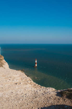 Red and whiteâstriped Beachy Head Lighthouse against chalk cliffs,  view from top of Seven Sisters, Clifftop Paths Nature Reserve. South of Englandのeditorial素材
