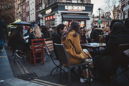 Soho, London | UK -  2021.04.16: People sitting in pubs and restaurants on Friday evening after ending of Coronavirus Lockdownのeditorial素材