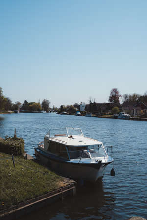 Staines-upon-Thames, Spelthorne | UK -  2021.04.24: Boats moored next to the beautiful houses on the river Thames in Stainesのeditorial素材