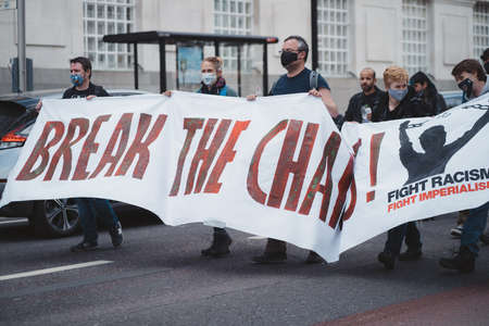 Westminster, London | UK -  2021.05.01: People wearing masks and waving flags and Break the chains banners at "Kill the Bill" protest.のeditorial素材