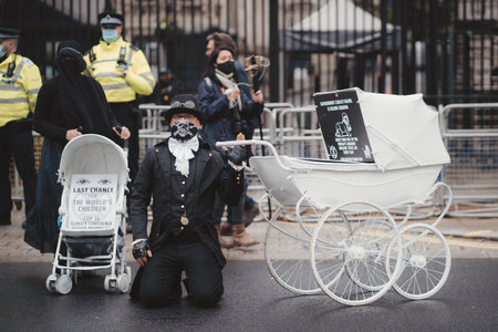 Westminster, London | UK -  2021.05.08: Extinction Rebellion activists kneeling in front of Downing...