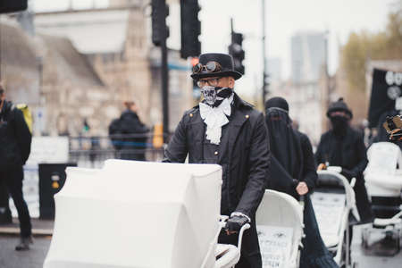 Westminster, London | UK -  2021.05.08: Extinction Rebellion activists marching slowly towards Downing Street with White Baby Pramsのeditorial素材