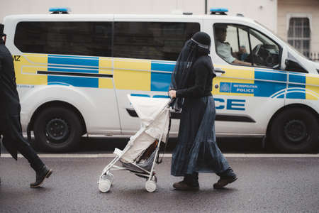 Westminster, London | UK -  2021.05.08: Extinction Rebellion activists marching next to Downing Street with White Baby Prams in front of Police officersのeditorial素材