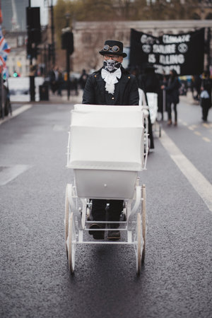 Westminster, London | UK -  2021.05.08: Extinction Rebellion activists marching slowly towards...