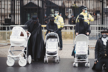 Westminster, London | UK -  2021.05.08: Extinction Rebellion activists kneeling in front of Downing...