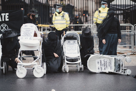 Westminster, London | UK -  2021.05.08: Extinction Rebellion activists kneeling in front of Downing...
