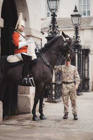 Westminster, London | UK -  2021.05.08: Traditional household cavalry guard in full uniform outside Hourse Guards Parade in Whitehallのeditorial素材