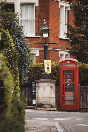 Richmond, London | UK - 2021.05.15: Empty red telephone booth in West London