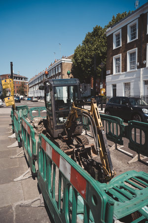 Vauxhall, London | UK - 2021.06.13: Small excavator at the road works in Vauxhall area