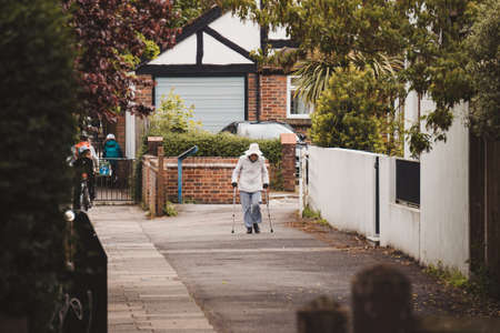 Richmond, London | UK - 2021.05.15: Elderly woman on a walk with crutches in West Londonのeditorial素材