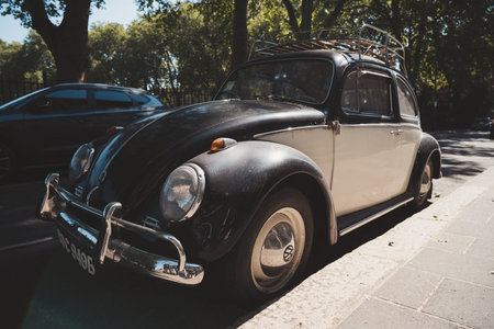 Vauxhall, London | UK - 2021.06.13: Black and white vintage VW Volkswagen bug parked on sunny day in...