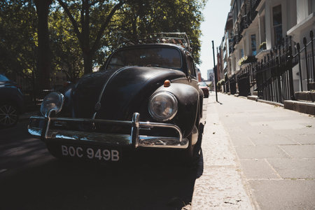 Vauxhall, London | UK - 2021.06.13: Black and white vintage VW Volkswagen bug parked on sunny day in...