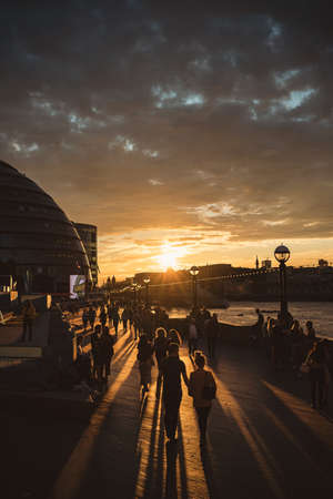 Thames River Embankment, London | UK - 2021.06.26: The view of the embankment and City Hall from the Tower Bridge with a beautiful sunset in the backgroundのeditorial素材
