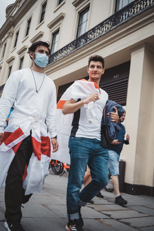 English people fans with flags and banners gathering at Trafalgar Square to watch the Final Euro 2020 Football gameのeditorial素材