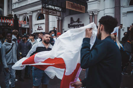 London | UK - 2021.07.12: English fans waving flags at Leicester Square before the final Euro 2020 Football gameのeditorial素材