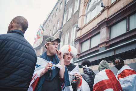 London | UK - 2021.07.12: English fans with flags gathering at Leicester Square to watch the Final Euro 2020 Football gameのeditorial素材
