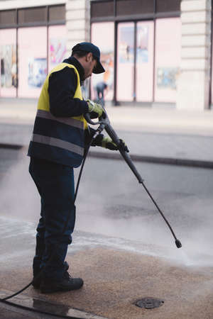 Westminster, London | UK -  2021.05.02: Man cleaning the sidewalks with high-pressureのeditorial素材