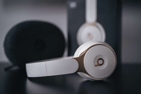 London | UK - 2021.10.09: Close up product photos of ivory Beats Solo Pro wireless bluetooth on-ear headphones with active noise cancelling on black deskのeditorial素材