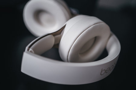 London | UK - 2021.10.09: Close up product photos of ivory Beats Solo Pro wireless bluetooth on-ear headphones with active noise cancelling on black deskのeditorial素材