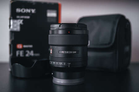 London | UK - 2021.10.09: Close up product photos of Sony FE 24mm F1.4 GM lens on black deskのeditorial素材