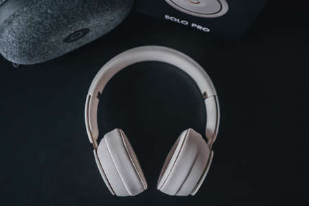 London | UK - 2021.10.09: Close up product photos of ivory Beats Solo Pro wireless bluetooth on-ear headphones with active noise cancelling on black deskのeditorial素材