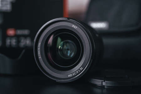 London | UK - 2021.10.09: Close up product photos of Sony FE 24mm F1.4 GM lens on black deskのeditorial素材