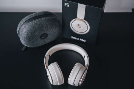 London | UK - 2021.10.09: Close up product photos of ivory Beats Solo Pro wireless bluetooth on-ear headphones with active noise cancelling on black deskのeditorial素材