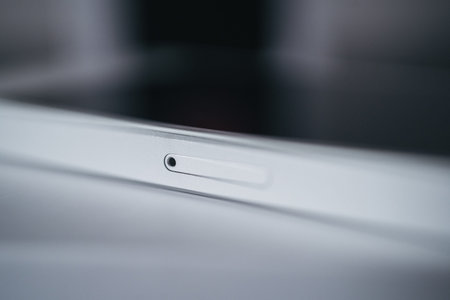 London | UK - 2021.10.09: Close up product photos of sim card slot of Iphone SE in silver color...
