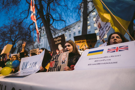 Downing Street, London | UK -  2022.02.25: Ukrainian people with banners and flags gather to demand...