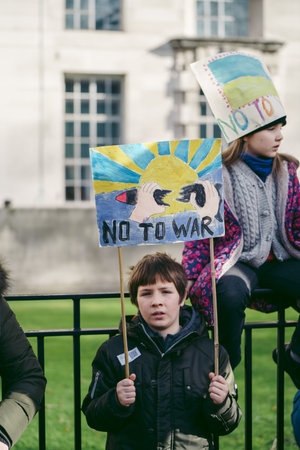 Downing Street, London | UK -  2022.02.26: Young ukrainian children with flags gather to demand tougher sanctions on Russia from British Government to stop war in Ukraineのeditorial素材