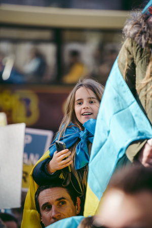 Downing Street, London | UK -  2022.02.26: Young ukrainian children with flags gather to demand tougher sanctions on Russia from British Government to stop war in Ukraineのeditorial素材