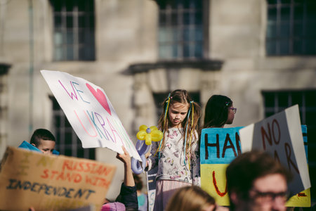 Downing Street, London | UK -  2022.02.26: Young ukrainian children with flags gather to demand tougher sanctions on Russia from British Government to stop war in Ukraineのeditorial素材
