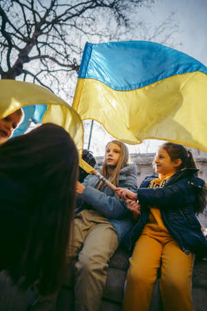 Downing Street, London | UK -  2022.02.26: Young ukrainian children with flags gather to demand tougher sanctions on Russia from British Government to stop war in Ukraineのeditorial素材