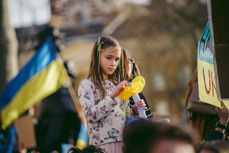 Downing Street, London | UK -  2022.02.26: Young ukrainian children with flags gather to demand tougher sanctions on Russia from British Government to stop war in Ukraineのeditorial素材