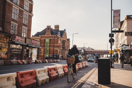 Shepherd's Bush, London | UK -  2021.03.22: woman ridia bike on the cycle laneのeditorial素材