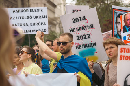Budapest | Hungary - 2022.03.08: People with flags in Budapest gather to support Ukrainians and stop...