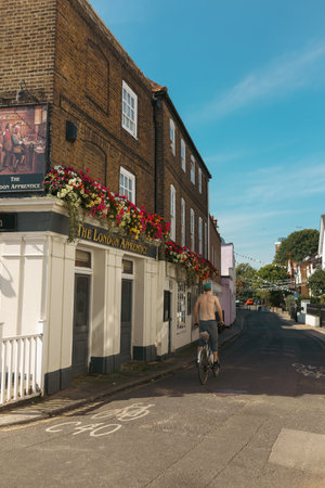 Richmond, London | UK - 2022.08.14: Top naked man cycling through Old Isleworthのeditorial素材