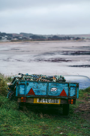 Jersey Island, Channel Island | UK - 2022.01.29: Small car trailer filled with crab cages park at the seasideのeditorial素材