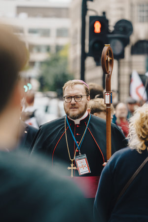 London, UK â€“ 2025.09.13 â€“ A religious leader dressed in traditional clerical attire holds a cross staff while joining a free speech protest in central London.