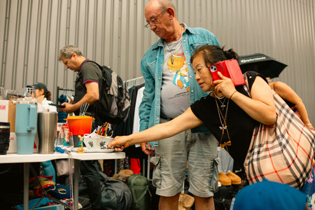 Vauxhall Market, London â€“ 2026-06-28 â€“ People browsing items at an indoor market table at in.