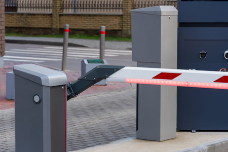 The automatic parking barrier is closed, effectively controlling access to the facility. Positioned...