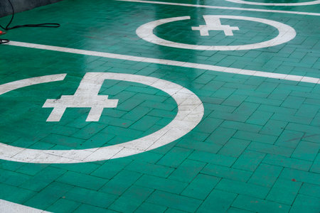Bright green parking spots designed for electric cars are visible, featuring distinct charging symbols.の写真素材